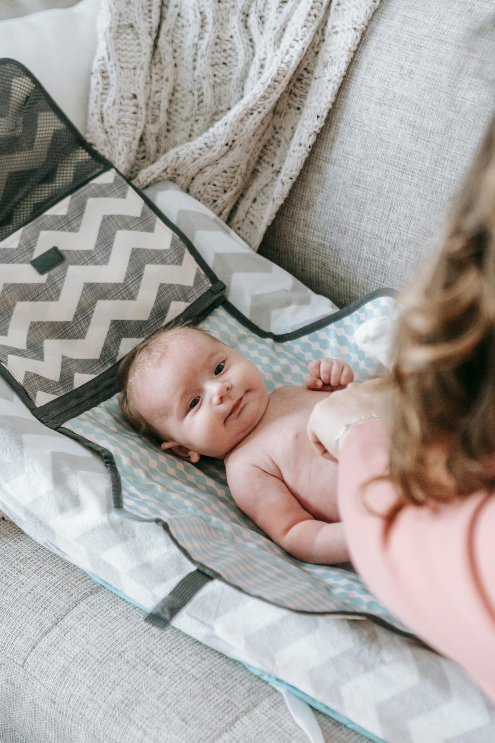 A person changing a baby | Source: Pexels