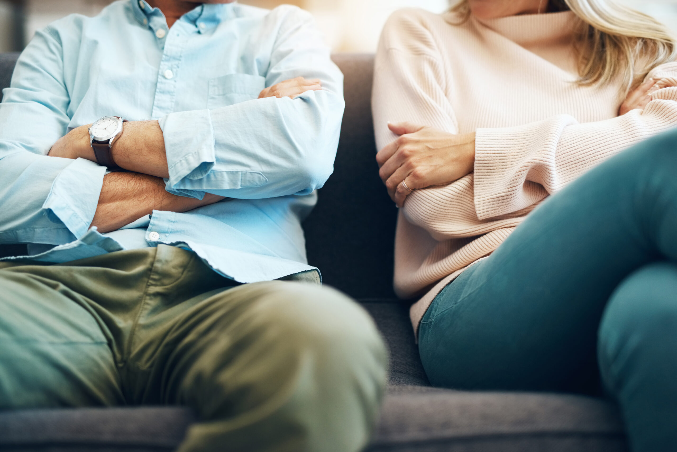 A couple sitting with arms crossed | Source: Getty Images