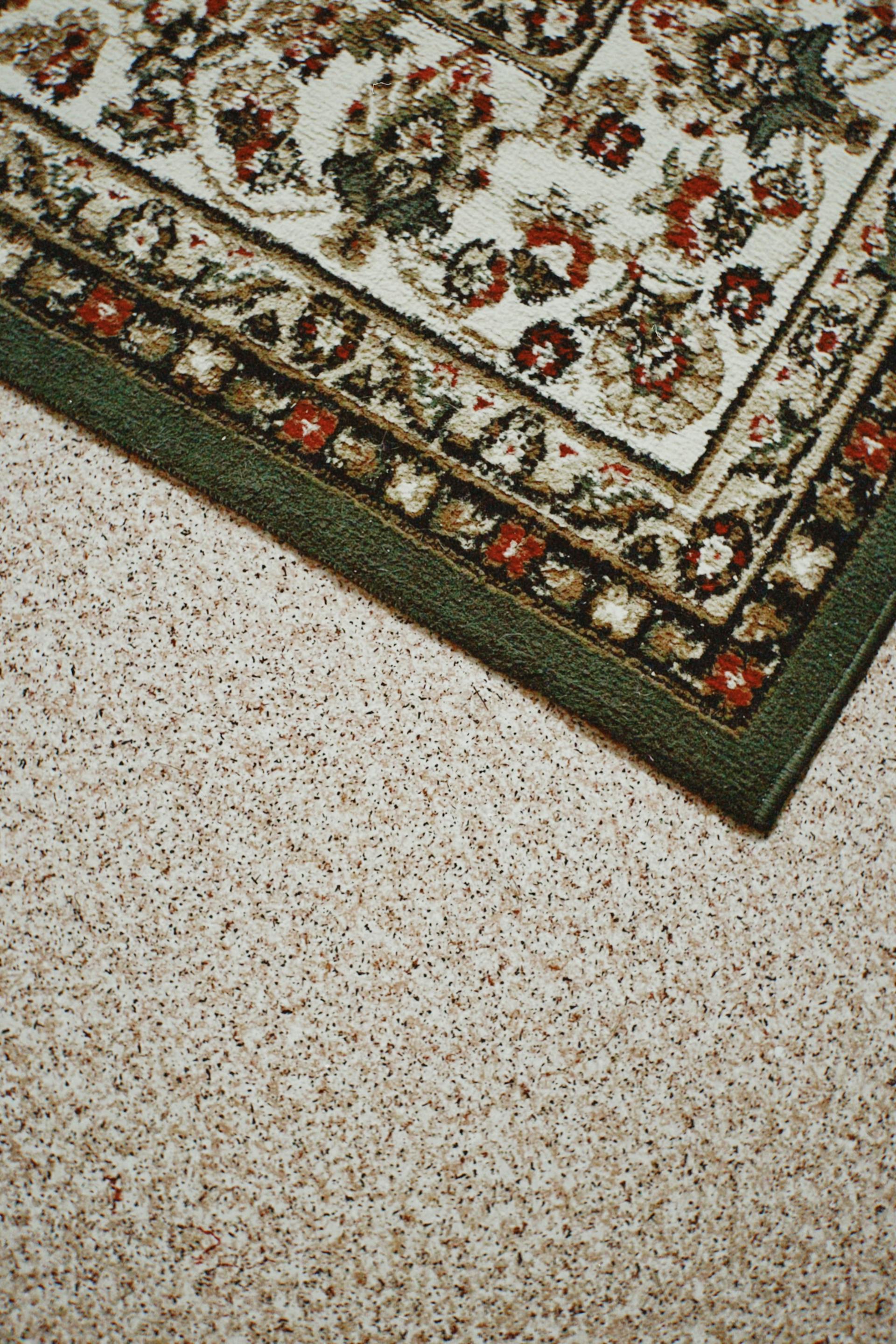 A close-up of a rug on a carpeted floor | Source: Pexels