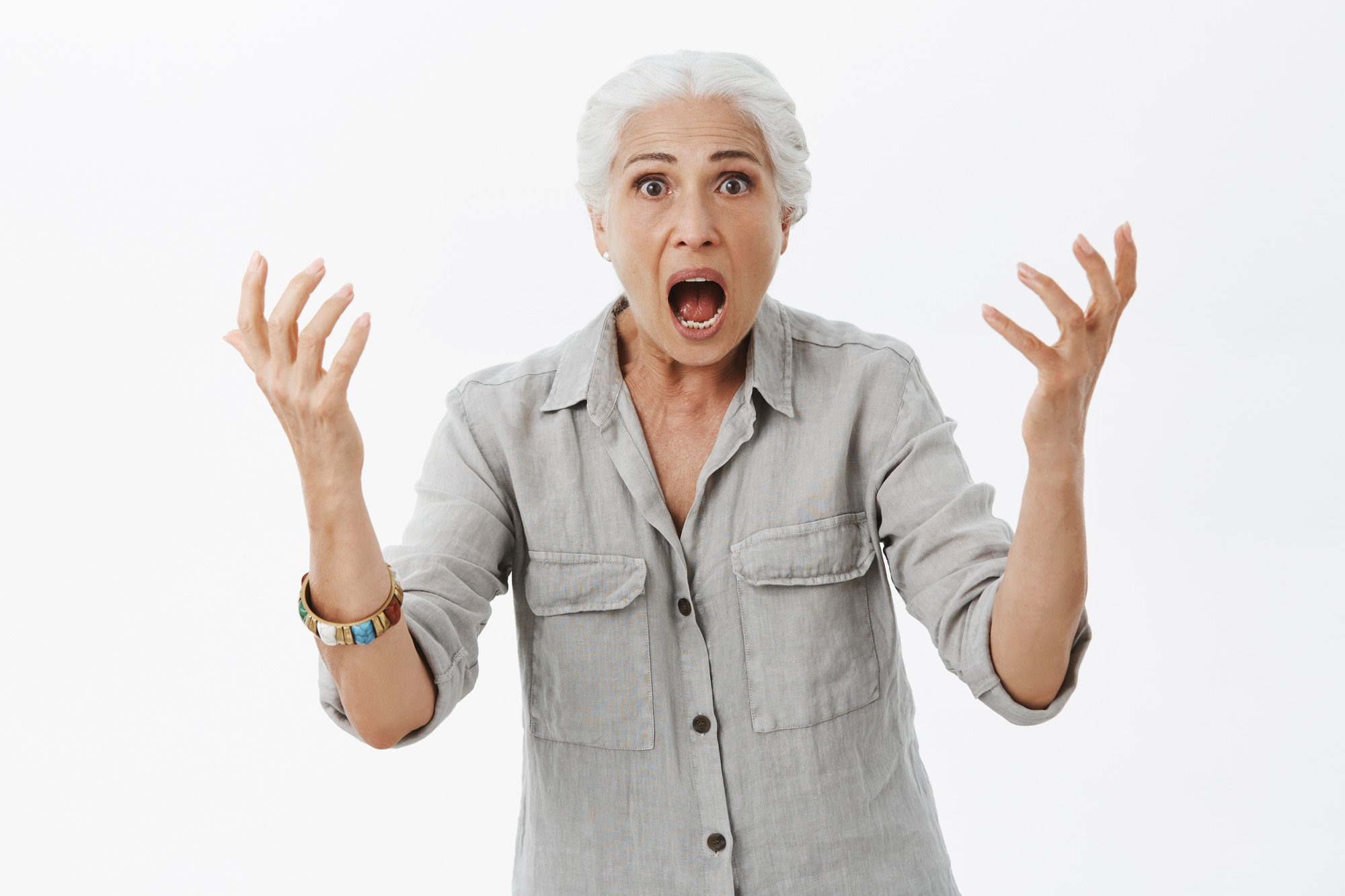 A woman gesturing anger with her mouth open | Source: Freepik