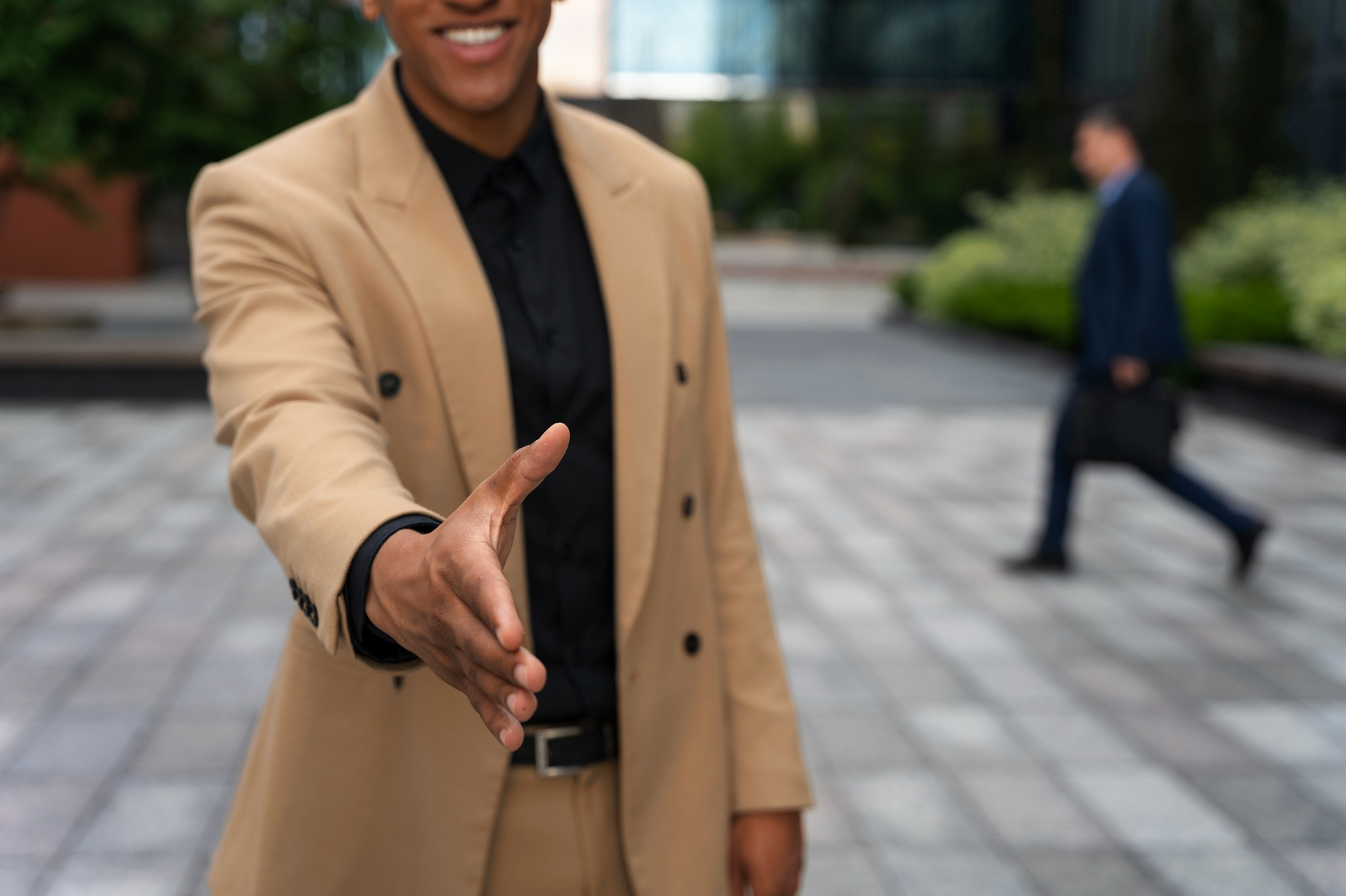 A man reaching out to shake someone