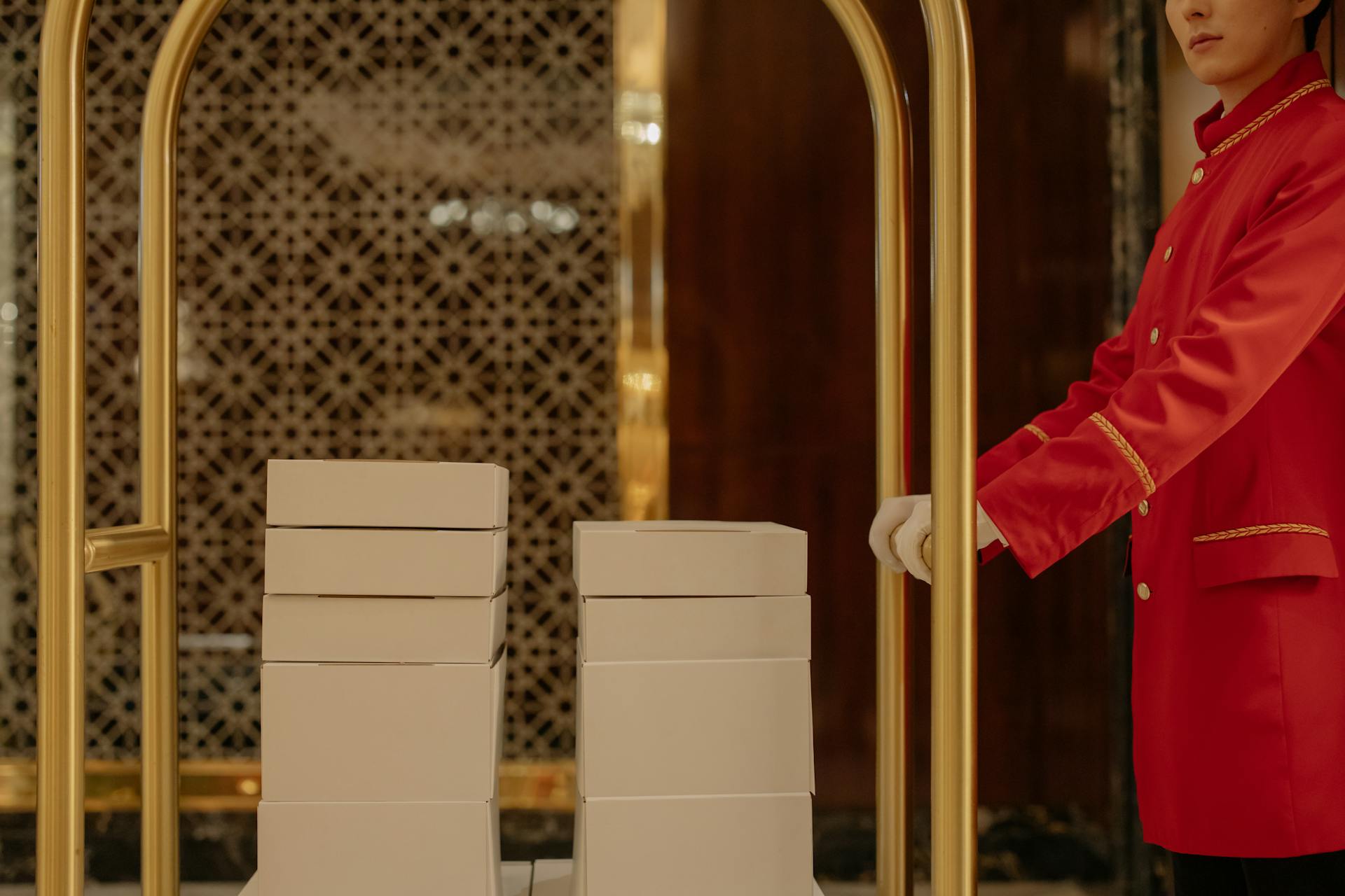 A hotel worker pushing a cart with boxes | Source: Pexels