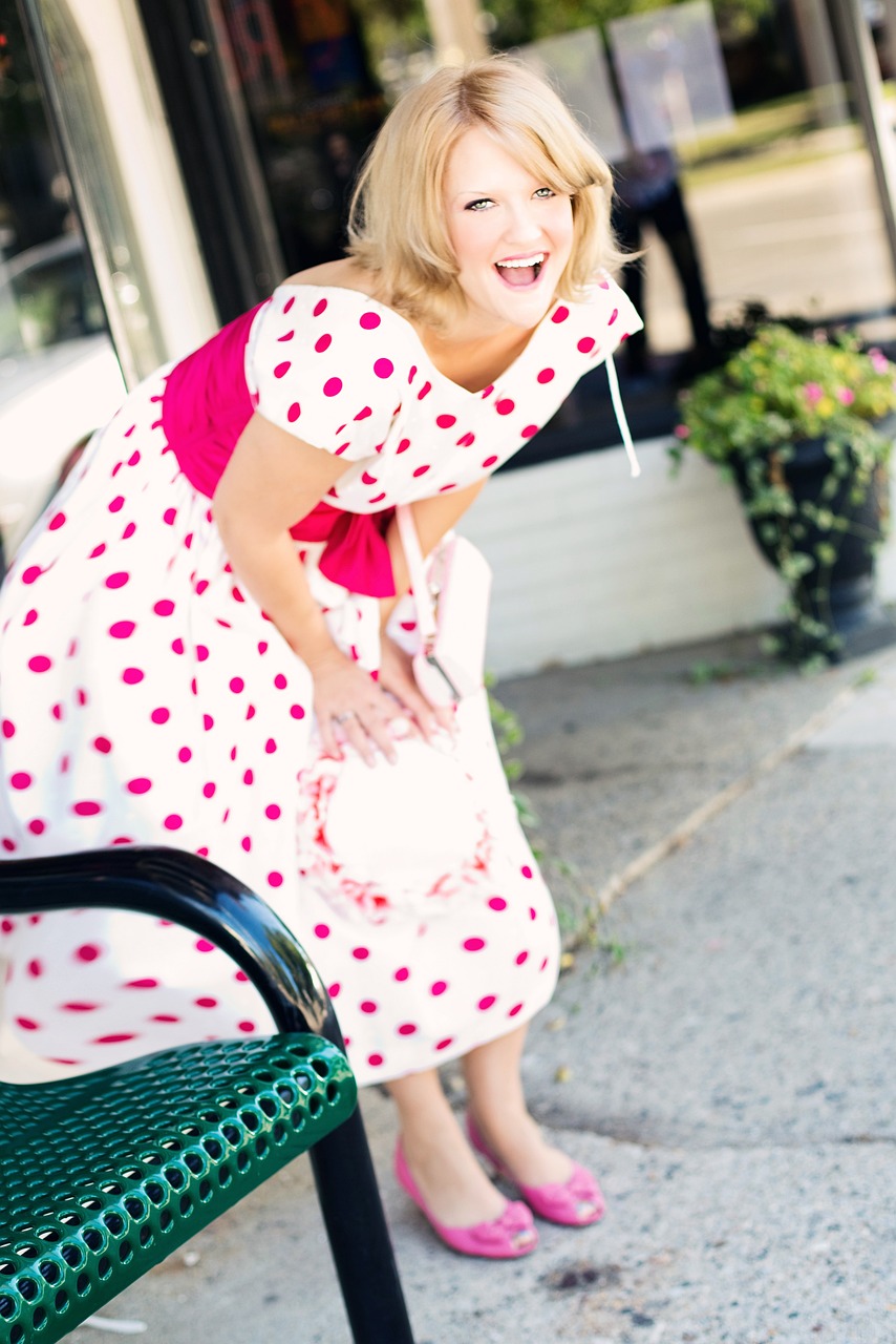 A woman in a vintage dress laughing | Source: Pixabay