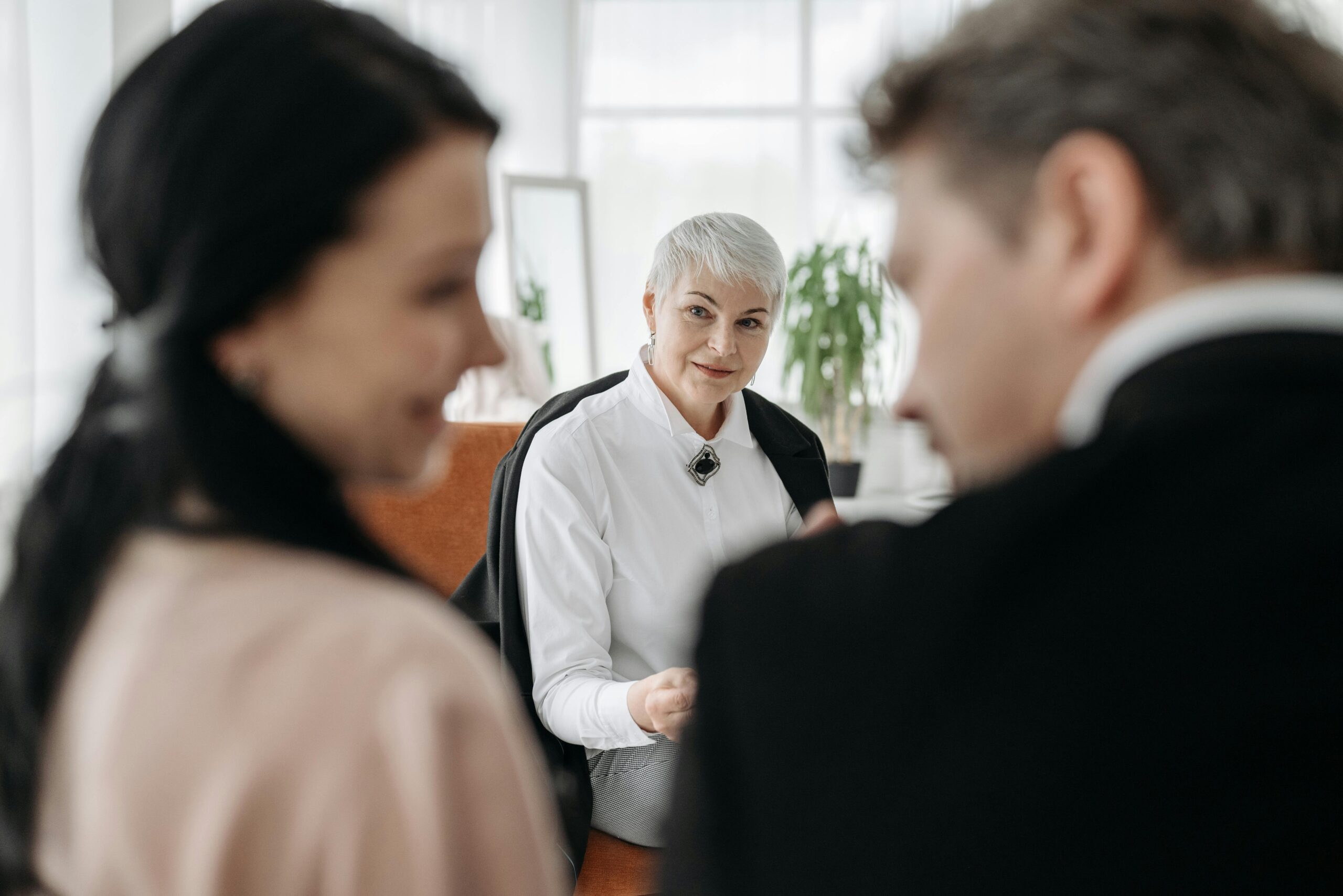 Young couple talking to an older woman | Source: Pexels