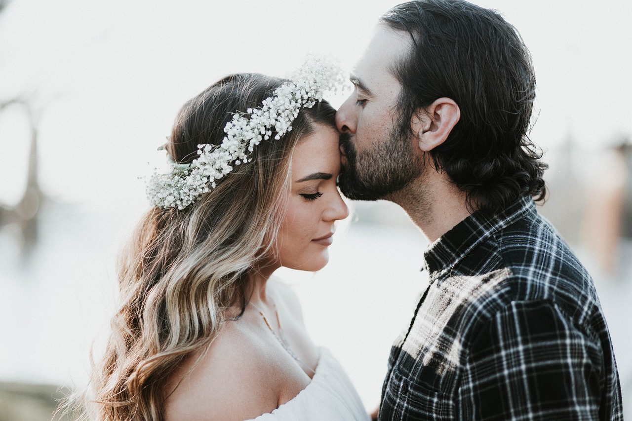 A man lovingly kissing his woman