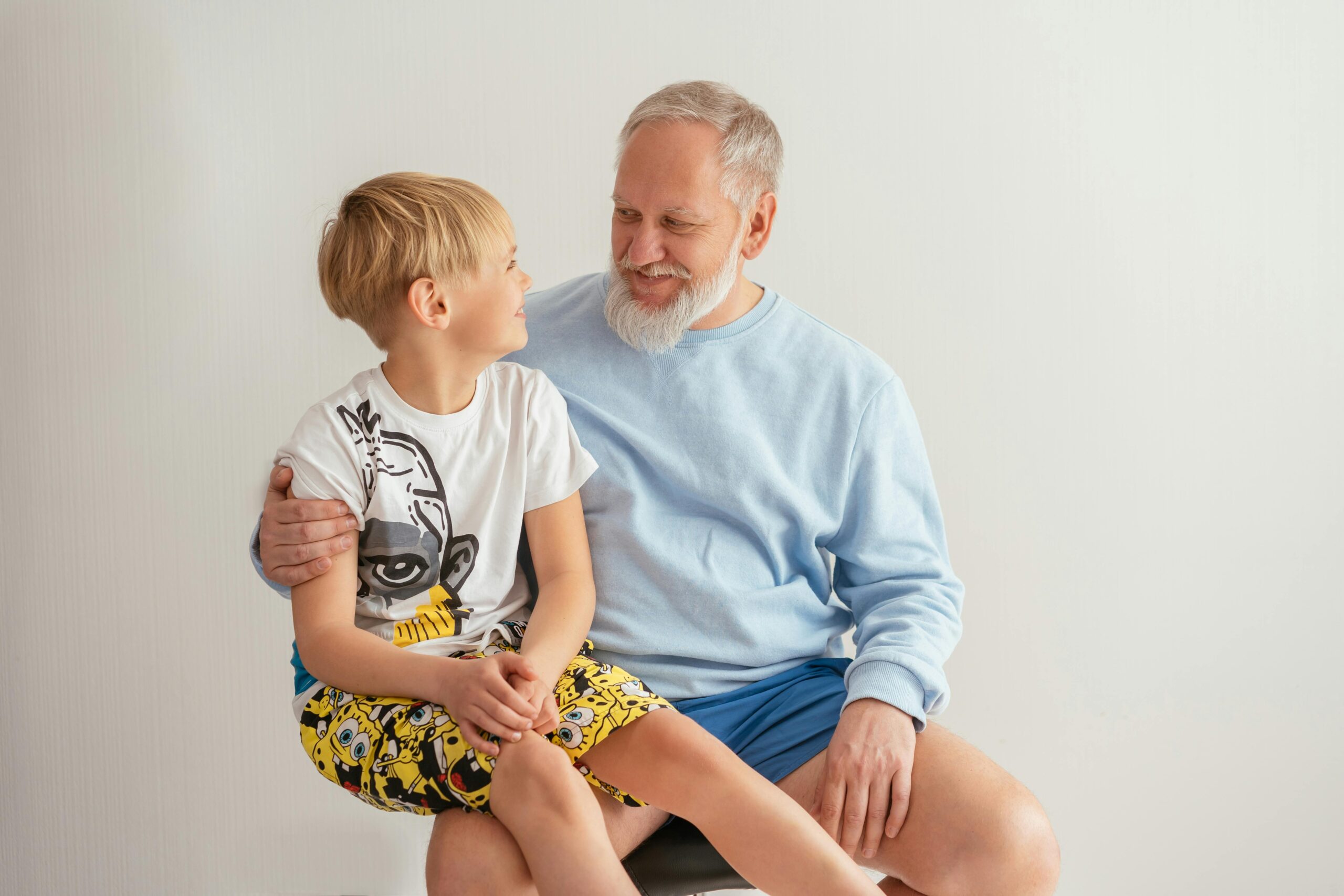 Young boy sitting on his grandfather