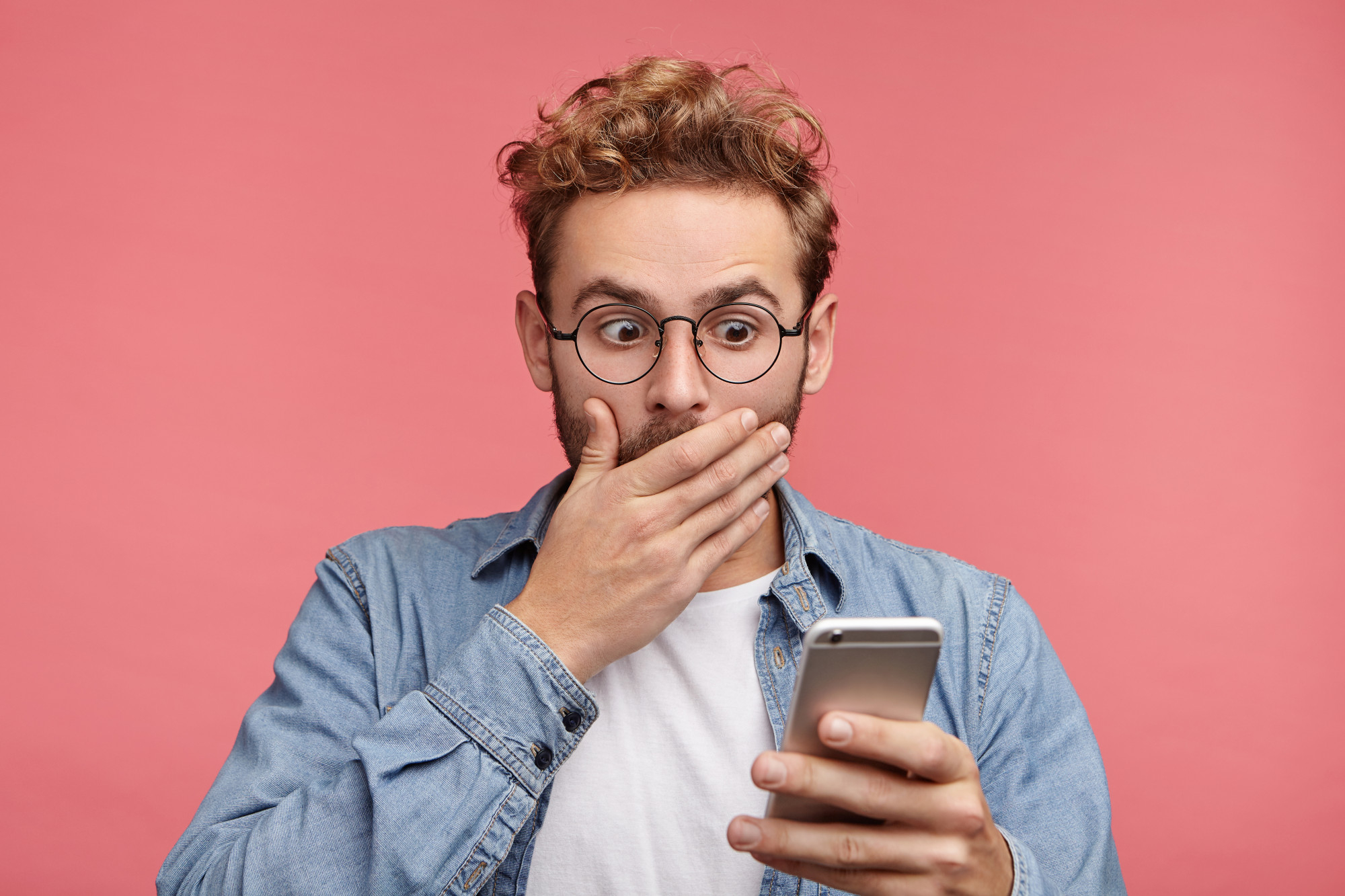 A man looking disturbed by something on his phone | Source: Freepik