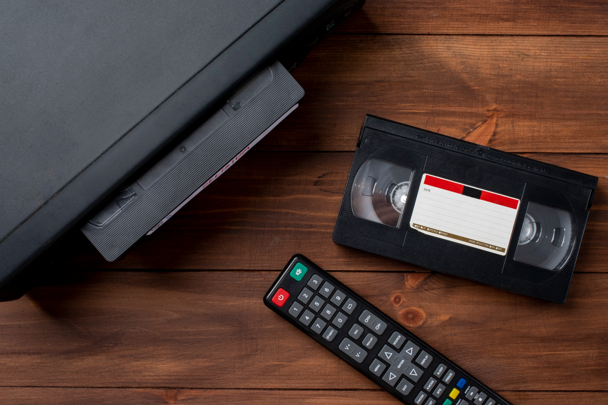 A VHS player with a tape and a remote control | Source: Freepik