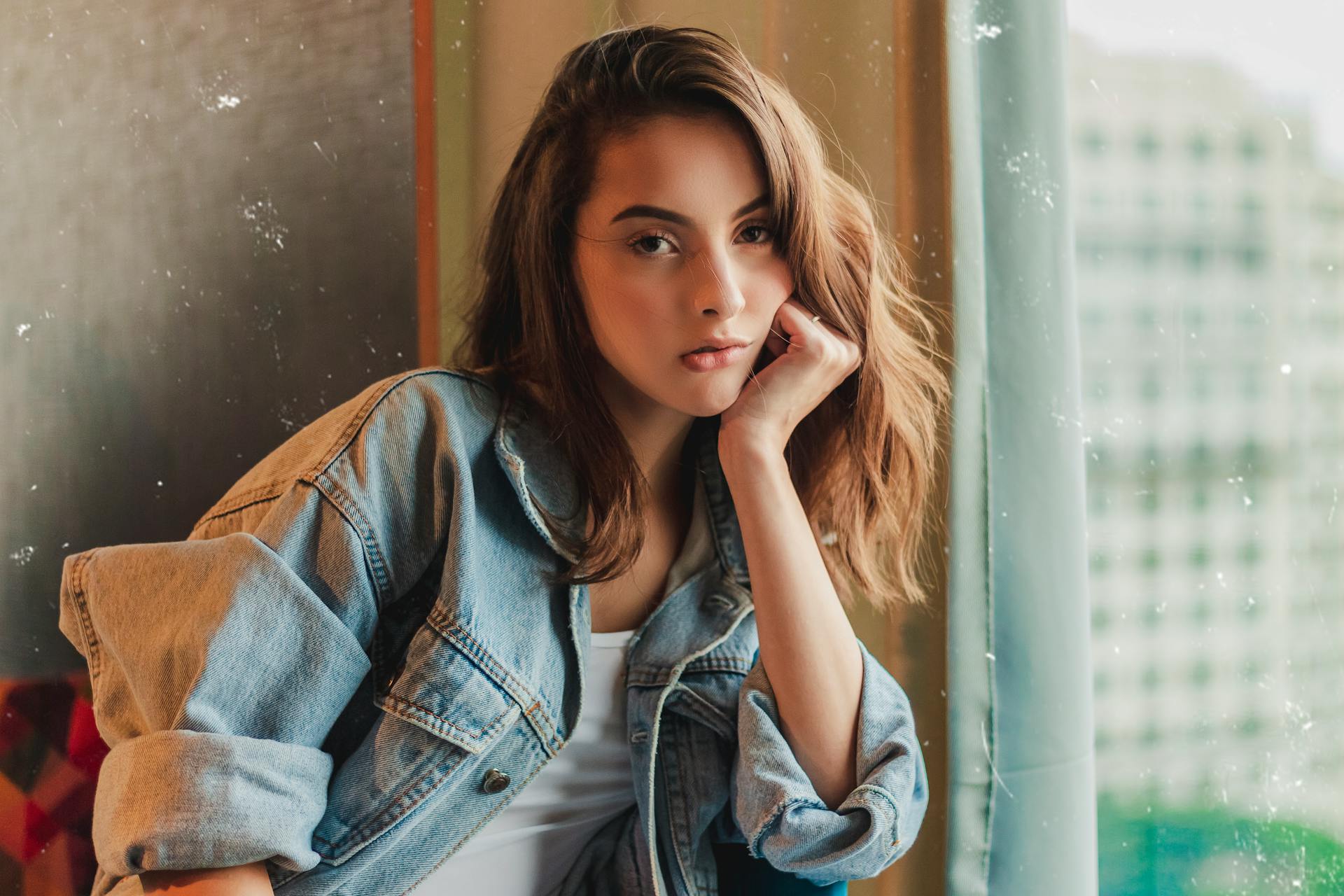 Young woman seated near a window | Source: Pexels