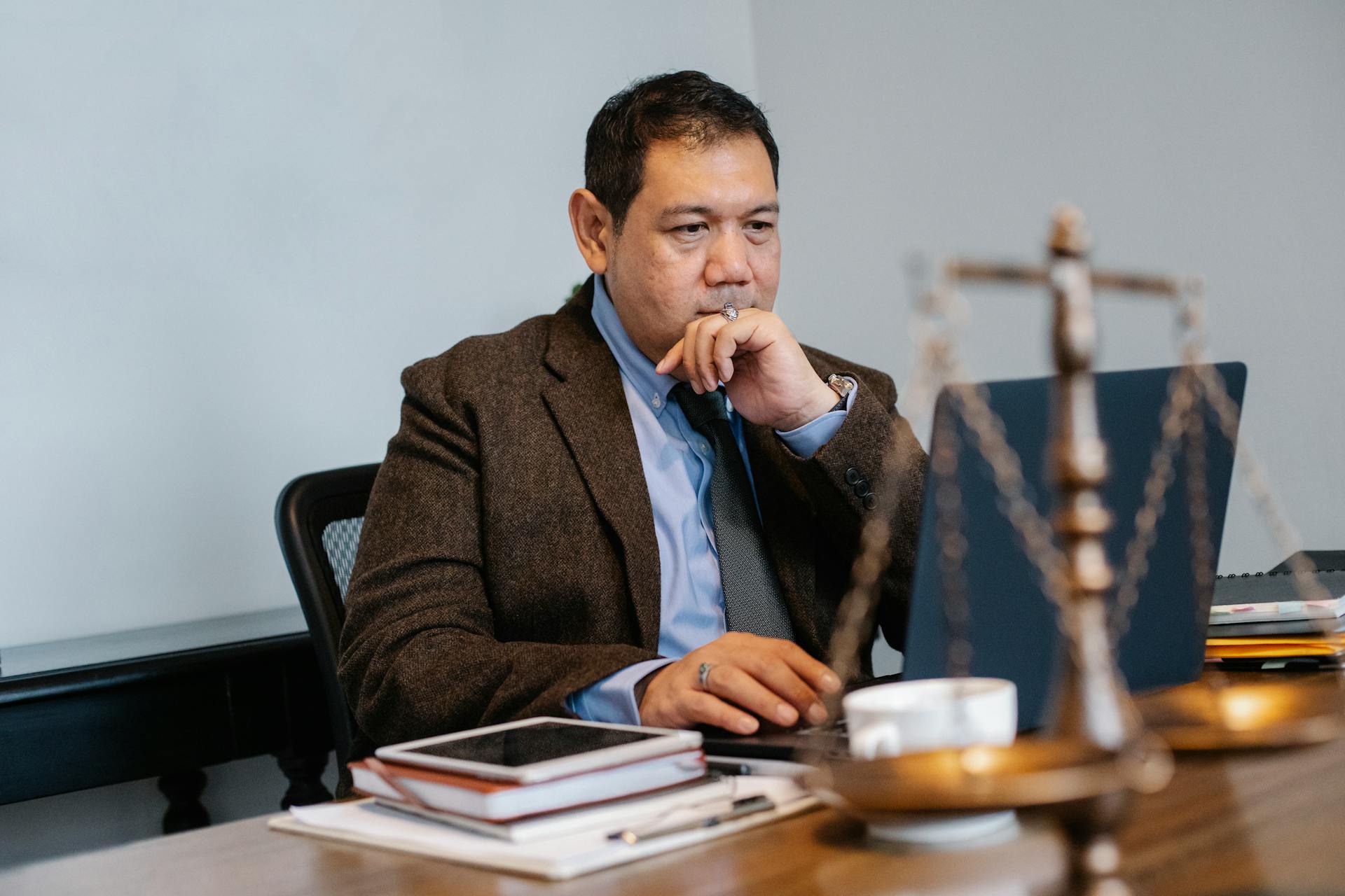A lawyer looking at his laptop screen | Source: Pexels
