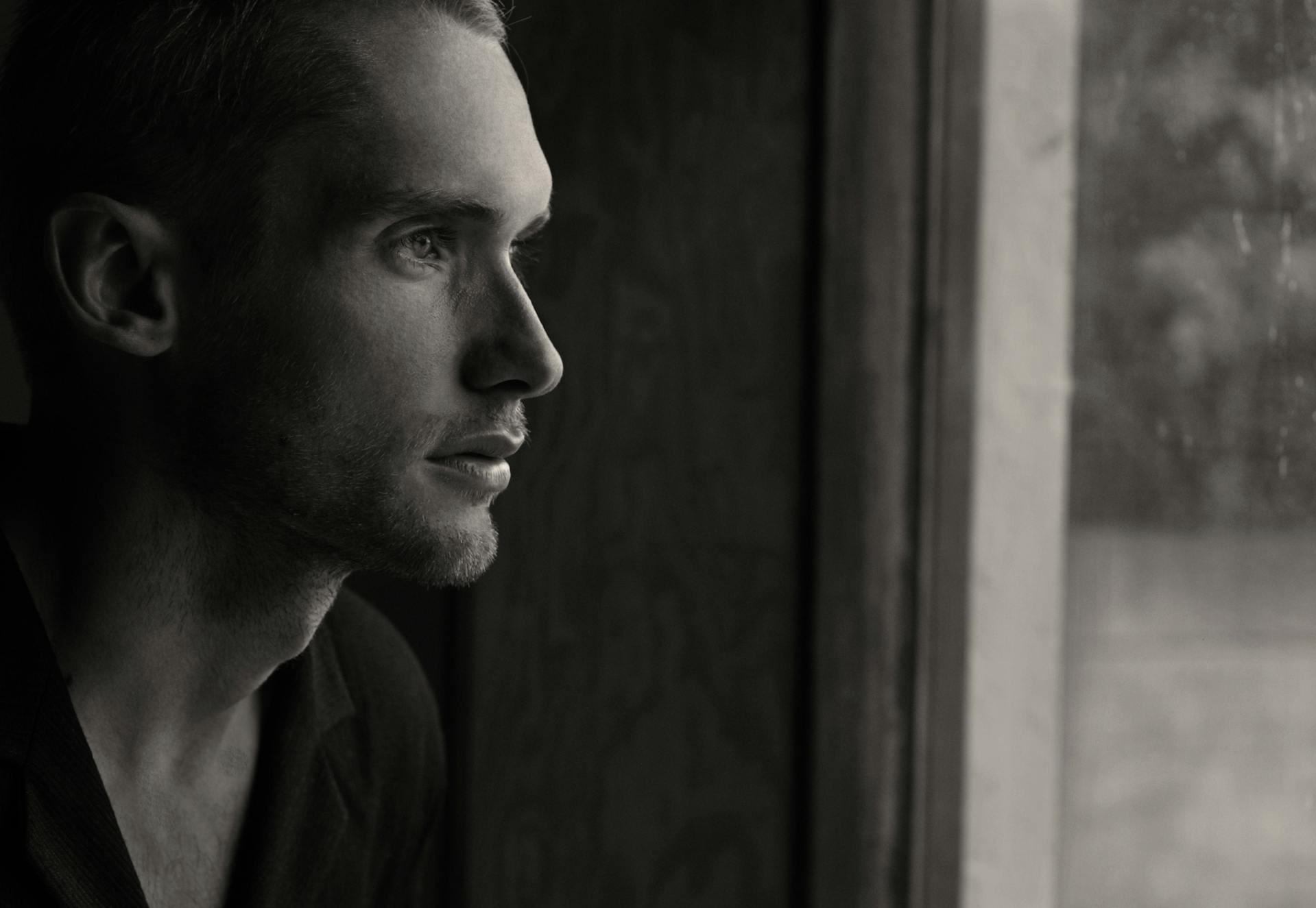 A thoughtful man staring out the window | Source: Pexels